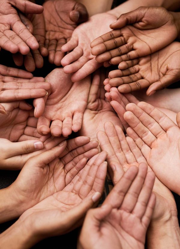 We need your support. Shot of a group of hands held cupped out together